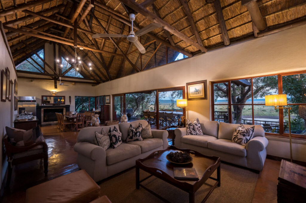Luxury main lodge interior with plush sofas and African artwork