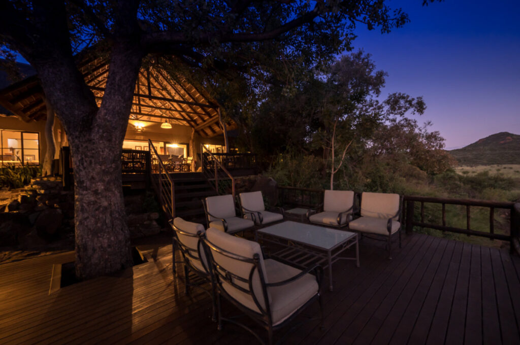 Exterior view of Tamboti Lodge luxury chalets at dusk
